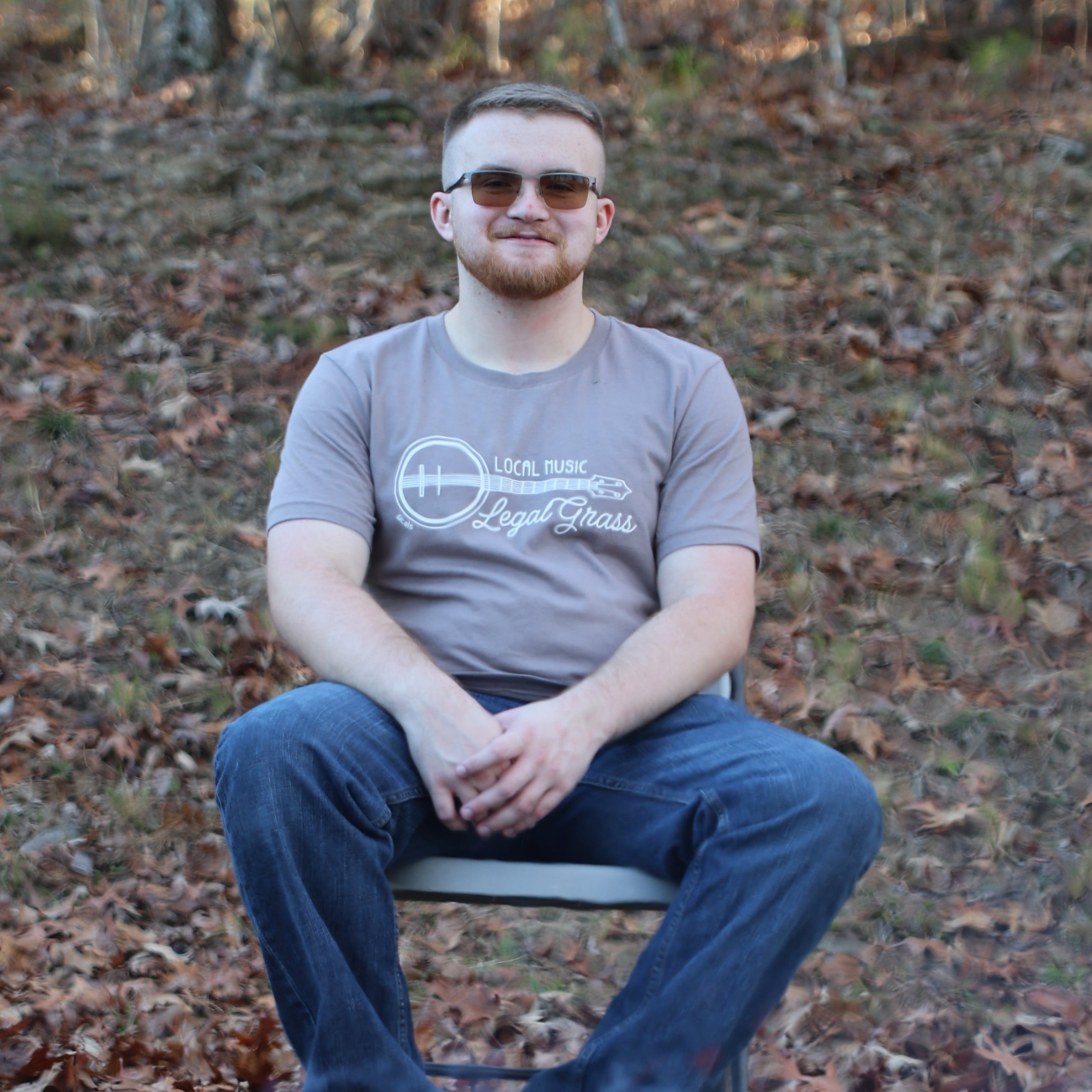 Person sitting by a campfire in a forest setting